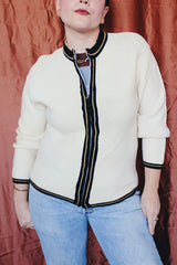 Women's vintage 1960's Brentwood Sportswear label long sleeve zip up cardigan in a waffle knit cream color. Has black and tan trim throughout.