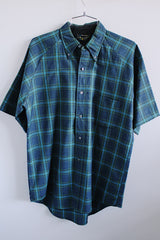 Men's vintage 1960's Penneys, Made in Japan label short sleeve button up shirt with collar in navy blue with all over blue and green plaid print.
