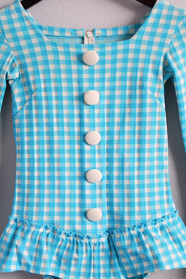 Women's vintage 1970's long sleeve light blue and white checkered bodysuit with ruffled trim, cuffs, and decorative buttons.