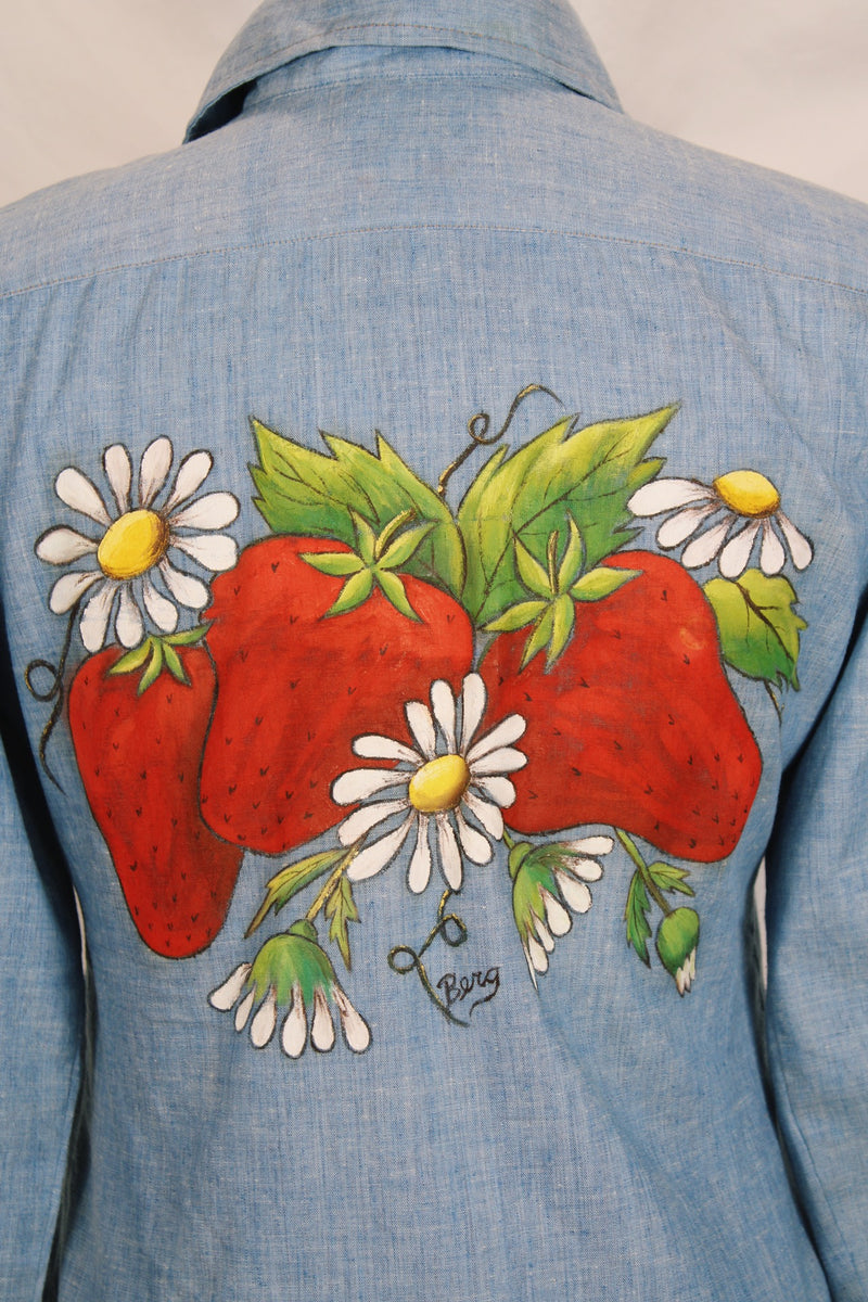 Women's vintage 1970's long sleeve light blue chambray denim shirt with large strawberry print on the back.