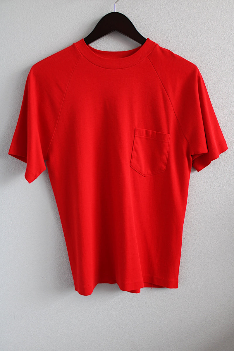 Men's or women's vintage 1980's short sleeve bright red t-shirt with one left chest pocket and a ribbed collar. 