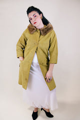 Women's vintage 1960's long sleeve long length button up suede coat with fur trim on collar. Mustard yellow color. Has pockets and side slits.
