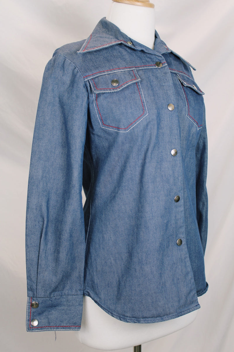 Women's vintage 1970's By Bogat of Texas long sleeve button up medium wash denim chambray top with red and white contrast stitching. 