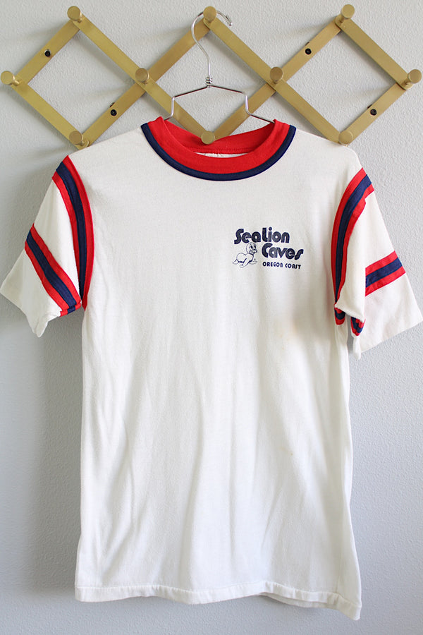 Women's or men's vintage 1980's Bantams label short sleeve white ringer tee with red and navy trim on arms and neckline. Sea lion coves Oregon Coast graphic on left chest.