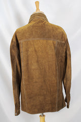 Men's or women's vintage 1970's long sleeve light brown tan colored suede jacket. Has silver snap buttons, contrast stitching, and a dagger collar.