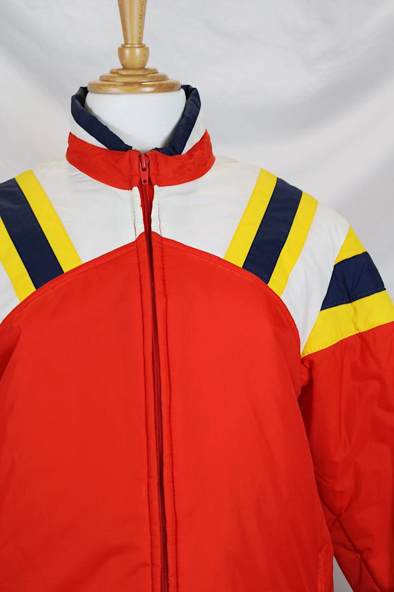 Men's or women's vintage 1980's JCPenney, Made in Hong Kong label long sleeve zip up puffy jacket in nylon material and red, blue, white, and yellow colors. 