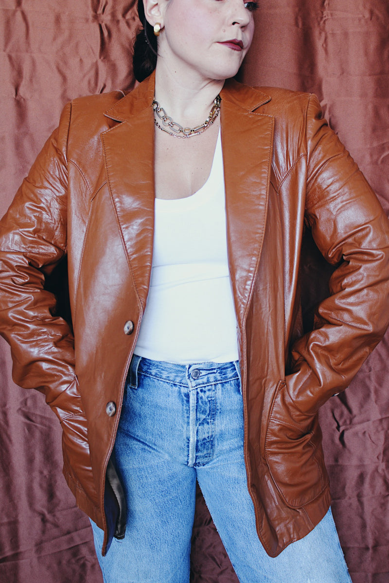 Women's or men's vintage 1970's Cresco label camel brown colored leather blazer jacket with two button closure and two front pockets.