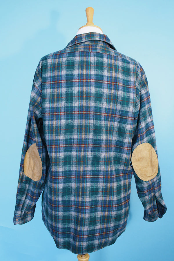 Men's vintage 1980's Pendleton, Made in USA label long sleeve plaid print button up shirt with tan elbow pads. Green and blue colors in a wool material.