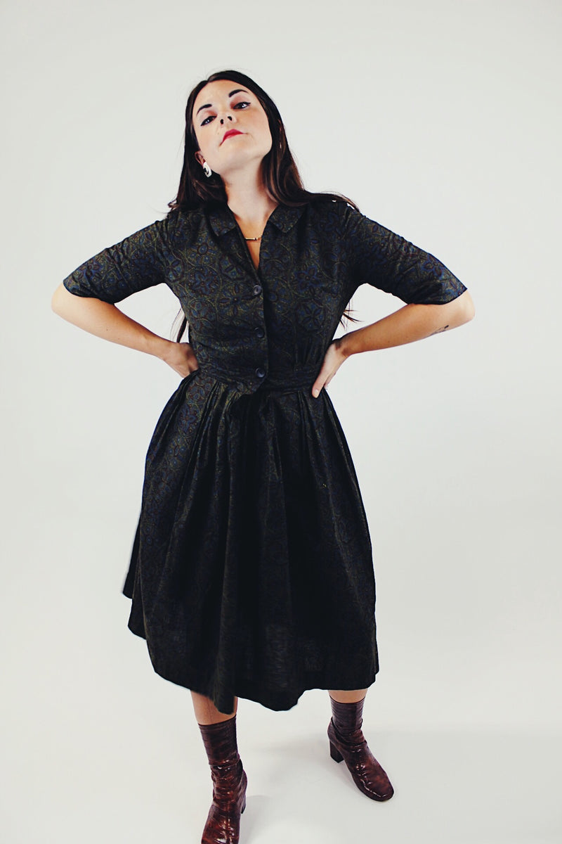 vintage 1950's paisley printed midi length dress with 3/4 arms and button up bust with small collar dark green front