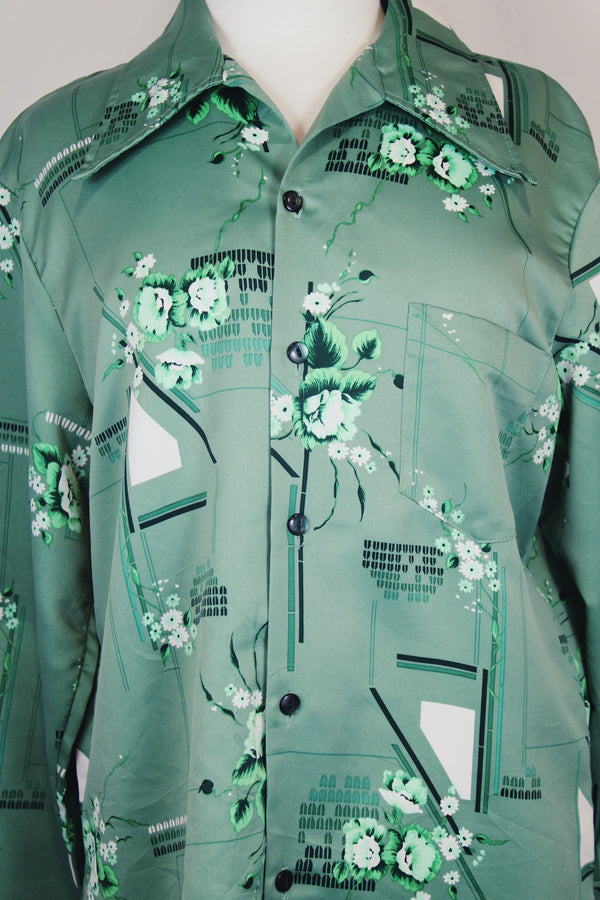 Men's vintage 1970's Don Giovanni California label long sleeve green colored button up shirt with all over floral print in a thick polyester material. 
