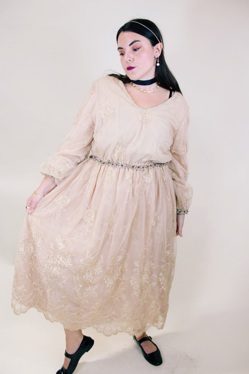 Women's vintage 1960's ankle length cream dress with lace overlay that has gold metallic detail. Beaded belt and beaded cuffs.