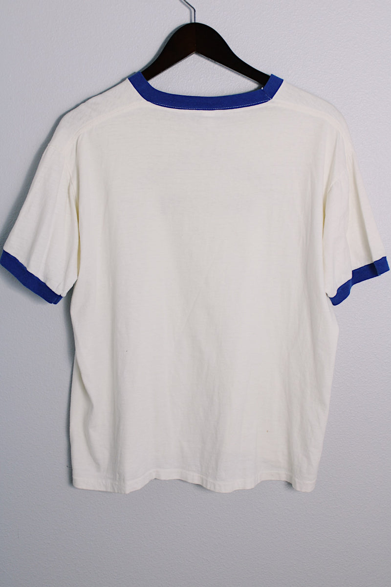 Men's or women's vintage 1970's Quality Sportswear Products, Made in USA label white ringer tee with blue trim and black graphic on the front. 