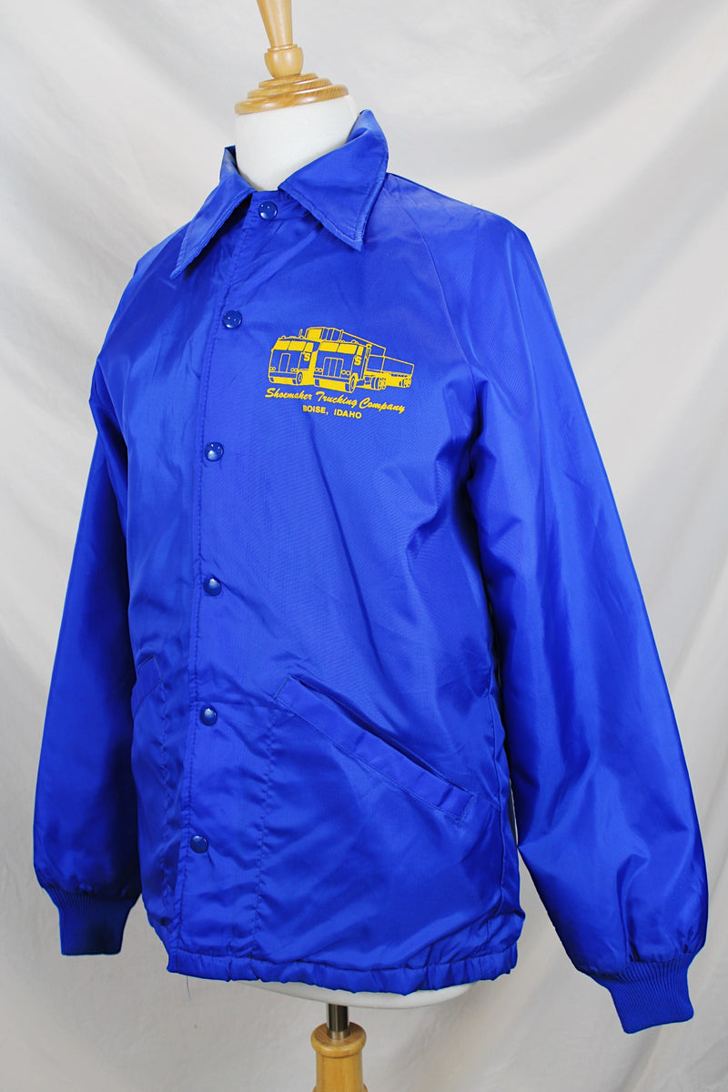 Women's or men's vintage 1980's Swingster, World of Wearables label long sleeve lightweight bright blue nylon windbreaker jacket with logo on left chest, popper buttons, and furry fleece liner.