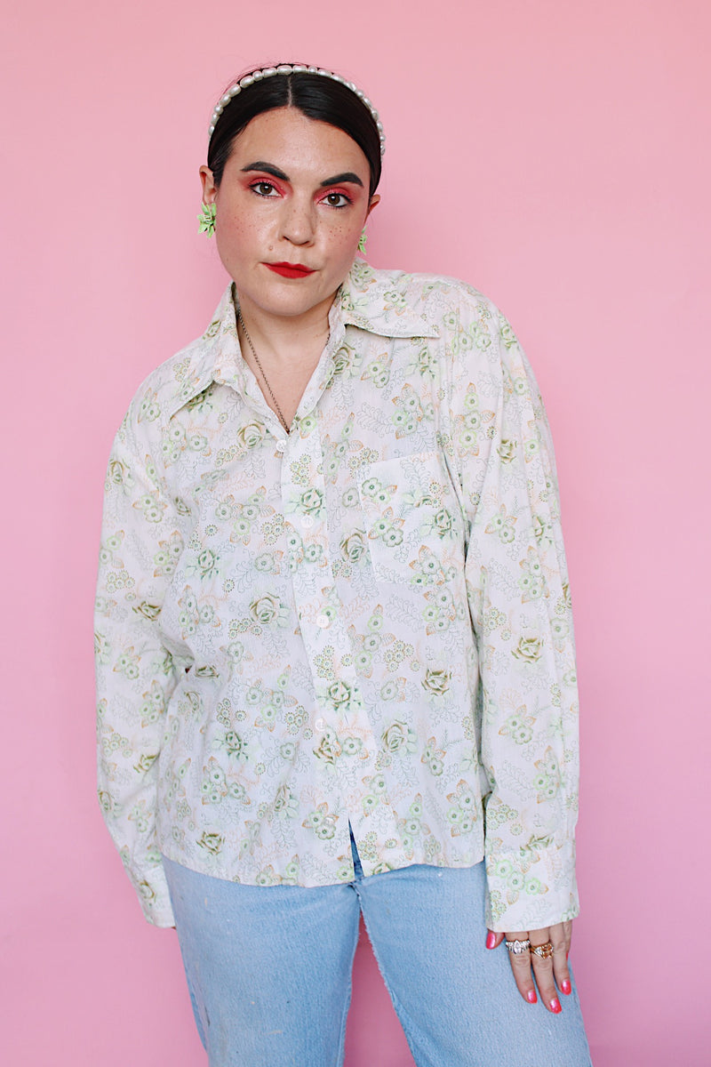 Men's or women's vintage 1970's Sutton Place label long sleeve button up shirt in white with all over green floral print. 