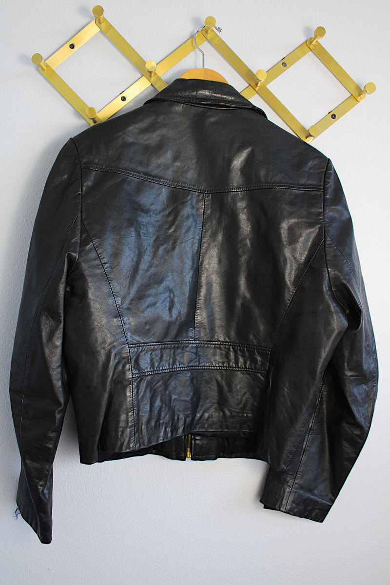 Women's or men's vintage 1970's Genuine Leather, Made in Uruguay long sleeve zip up black leather jacket with brass zippers and four front pockets