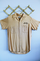 Men's or women's vintage 1960's Hilton, single needle sleeve label short sleeve button up bowling shirt in a beige tan cotton material.