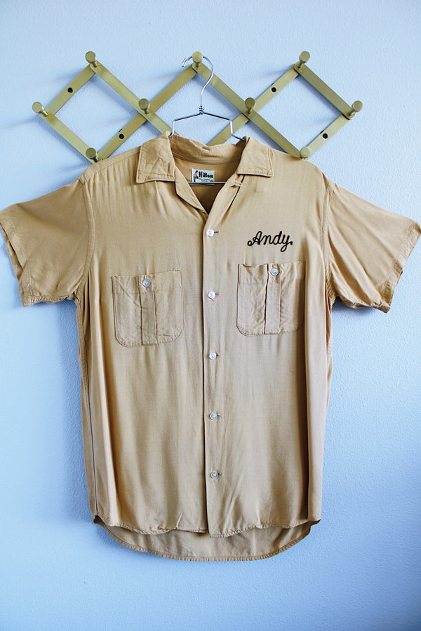 Men's or women's vintage 1960's Hilton, single needle sleeve label short sleeve button up bowling shirt in a beige tan cotton material.