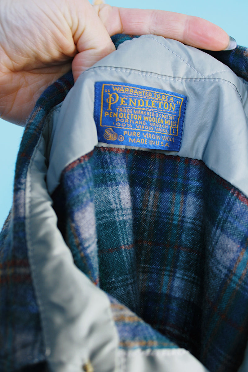 Men's vintage 1980's Pendleton, Made in USA label long sleeve plaid print button up shirt with tan elbow pads. Green and blue colors in a wool material.