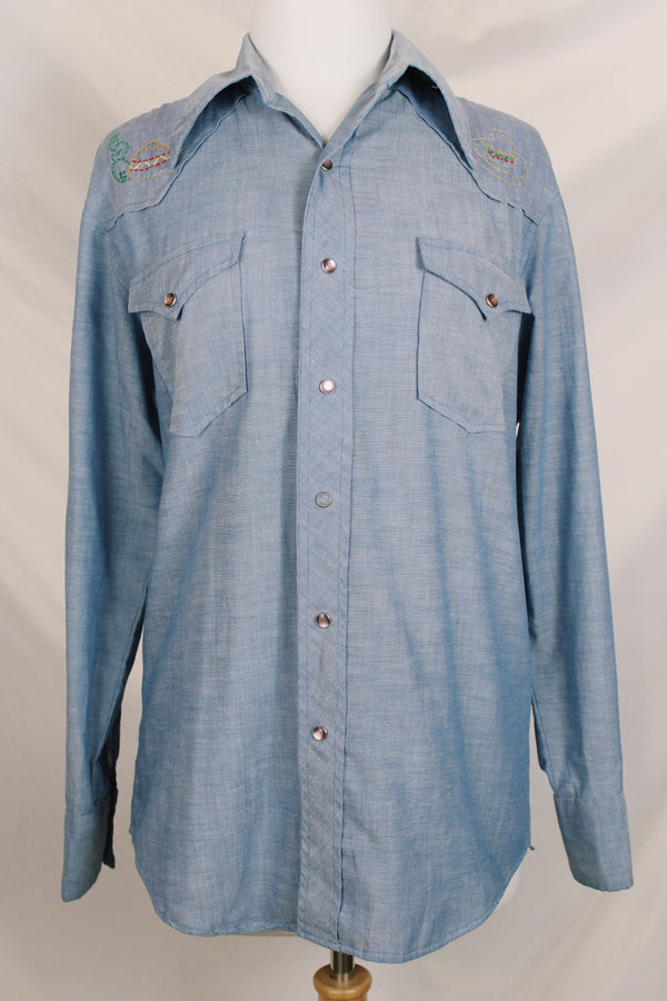 Men's vintage 1970's long sleeve chambray denim shirt with colored embroidery in the front and back. 