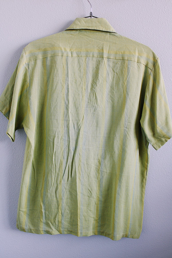 Men's vintage 1960's Sears label short sleeve button up shirt with collar and one left chest pocket in a lime green striped cotton material. 