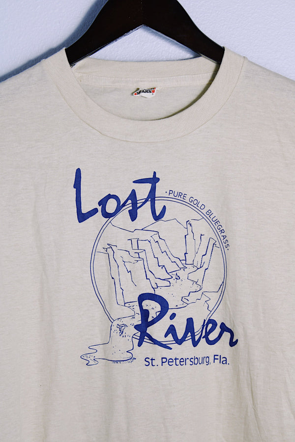 Men's or women's vintage 1980's Screen Stars, Made in USA label short sleeve light tan colored tee with blue graphic on the front in a cotton and polyester material. 
