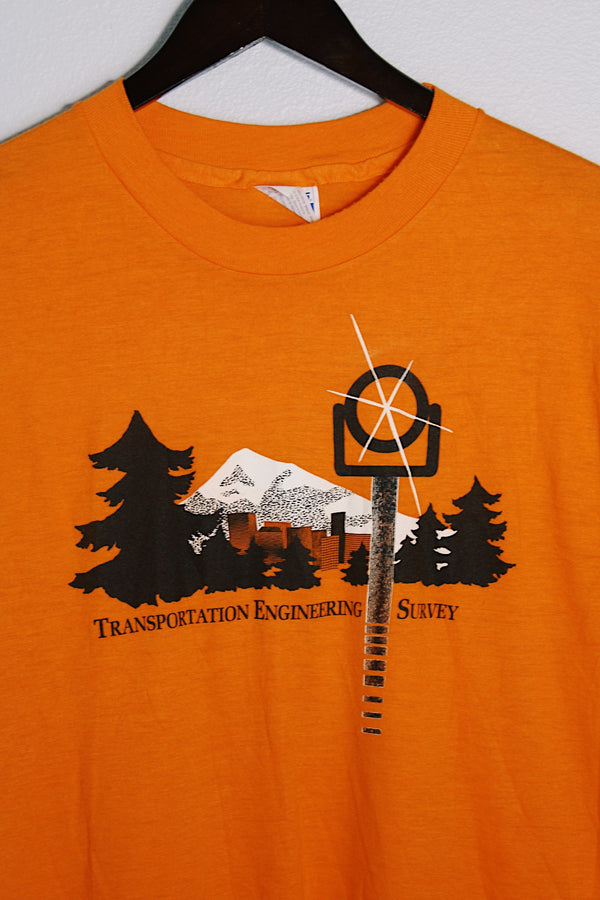 Women's or men's vintage 1980's Hanes, Fifty-Fifty, Made in USA label short sleeve orange tee with graphic on the front in black and white in a Polyester and cotton material. 