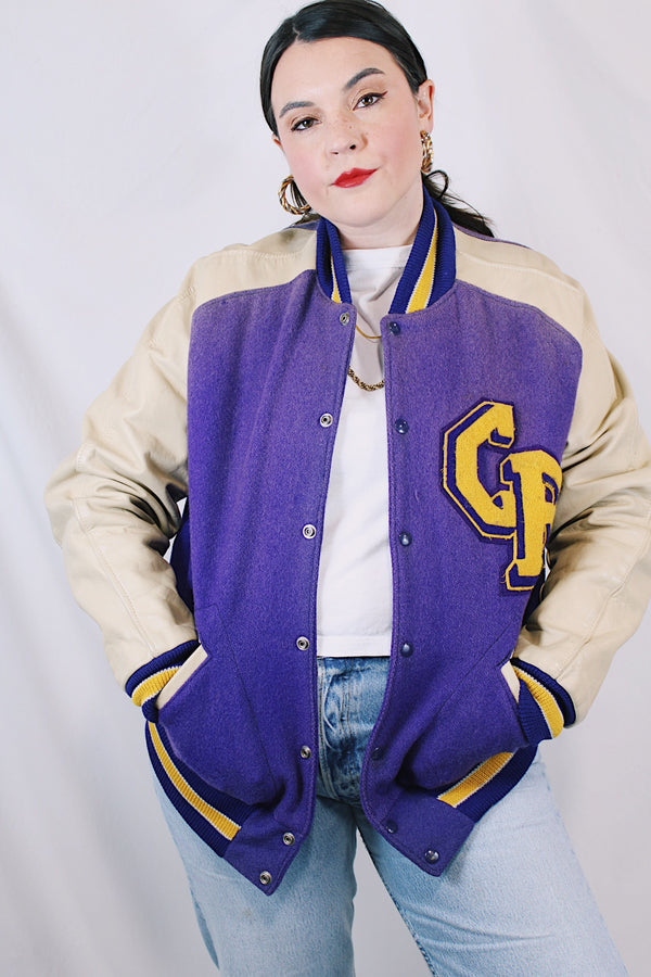 Women's or men's vintage 1960's Shields, Sporting Goods Inc., Vancouver, Washington label long sleeve wool and leather varsity letterman jacket in purple, cream, and yellow colors. 