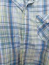 Men's vintage 1980's Levi's label short sleeve button up shirt in plaid print. Blue, white, yellow, green, and burnt orange. Lightweight Cotton materials.
