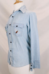 Men's or women's vintage 1970's JCPenney label long sleeve light blue chambray denim shirt with all over colored embroidery. 