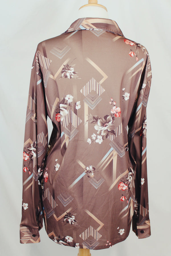 Men's vintage 1970's Montgomery Ward label long sleeve light brown colored button up shirt with all over floral print. 