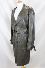 Men's or women's vintage 1970's Made in Argentina label knee length dark grey colored leather trench coat with double lapel and button closure.