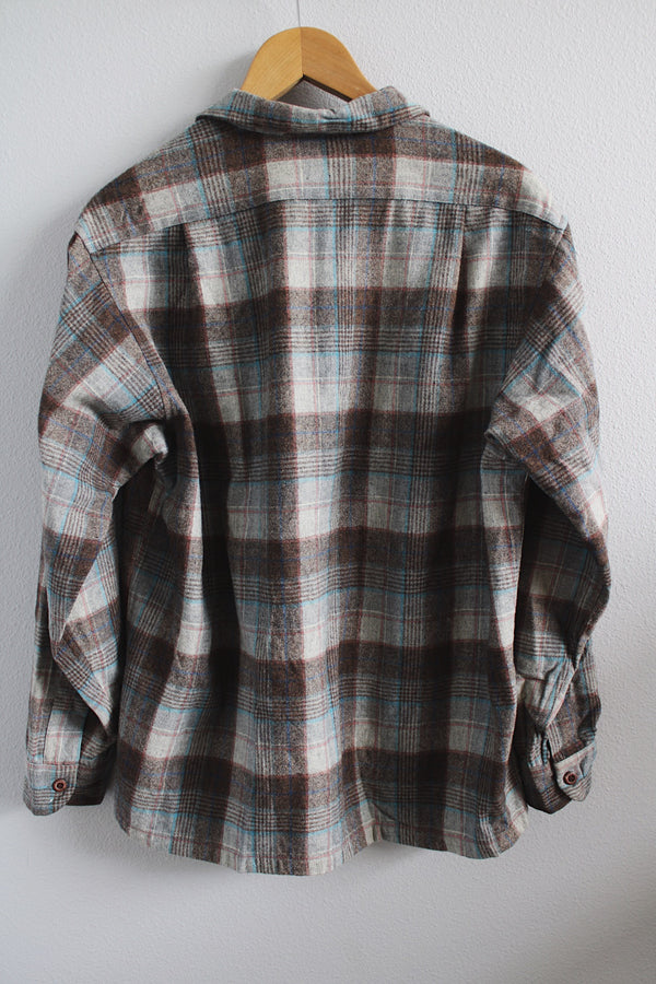 Men's vintage 1960's Pendleton size large long sleeve button up wool shirt in all over brown and blue plaid print. Two chest pockets. 