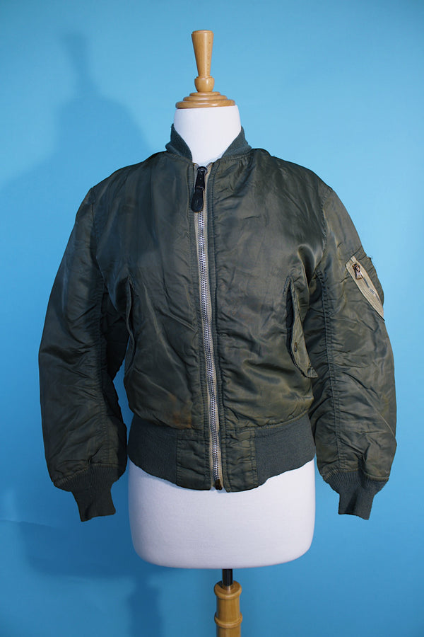 Women's or men's vintage army bomber jacket. Cropped and reversible in a Nylon material. One side is army green and one side in orange.