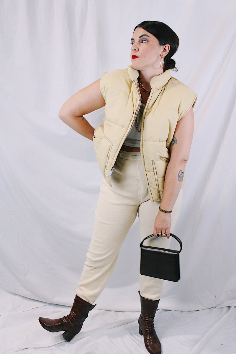 Women's or men's vintage 1970's A & M Industries, Seattle, Washington label sleeveless zip up puffer vest. Cream colored exterior, brown colored interior.