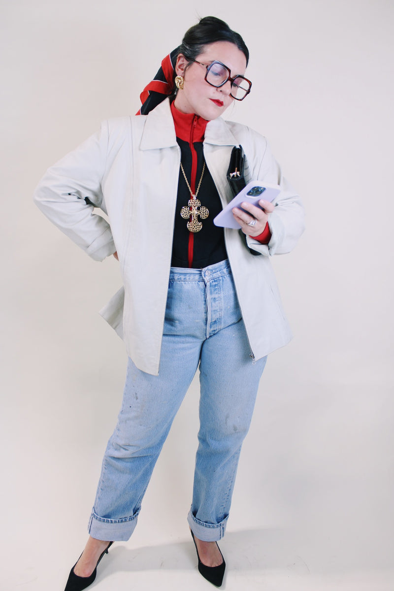 Women's vintage 1990's Worthington label long sleeve bone white leather jacket with a collar, a zipper up the front, and two side pockets.