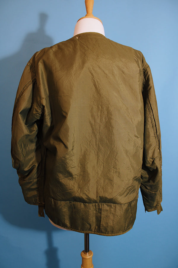 Men's or women's vintage 1950's long sleeve reversible army liner jacket. One side is a nubby cream color and one side is green Nylon. 