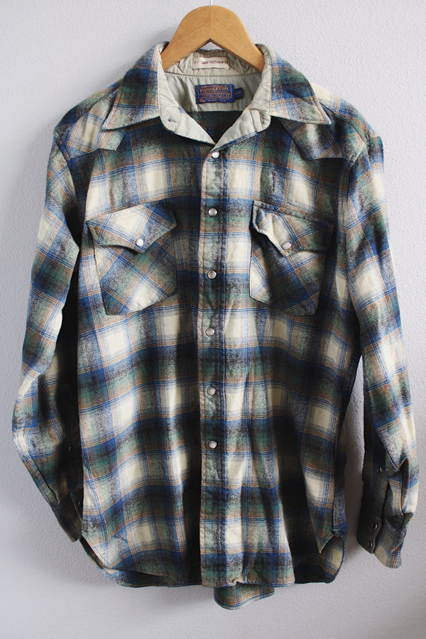 Men's vintage 1970's Pendleton, High Grade Western Wear size large long sleeve button up wool shirt in all over cream, blue, and green plaid print. Pearl popper buttons.