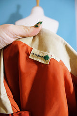 Women's or men's vintage 1980's Aspen label long sleeve zip up lightweight windbreaker jacket in tan and burn orange. 
