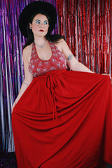 Women's vintage 1980's maxi length sleeveless red polyester halter wrap dress. Has silver sequins and beads on front chest.