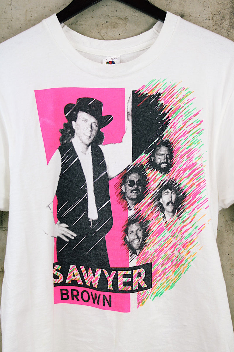 Women's or men's vintage 1990's Fruit of the Loom, Made in USA label short sleeve white Sawyer Brown band tee with multicolored graphic and text on front and back.