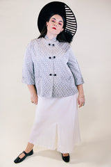 Women's vintage 1960's The Original Stork-A-Lure label long sleeve grey stain jacket with all over print. Black buttons up the front and mandarin collar.