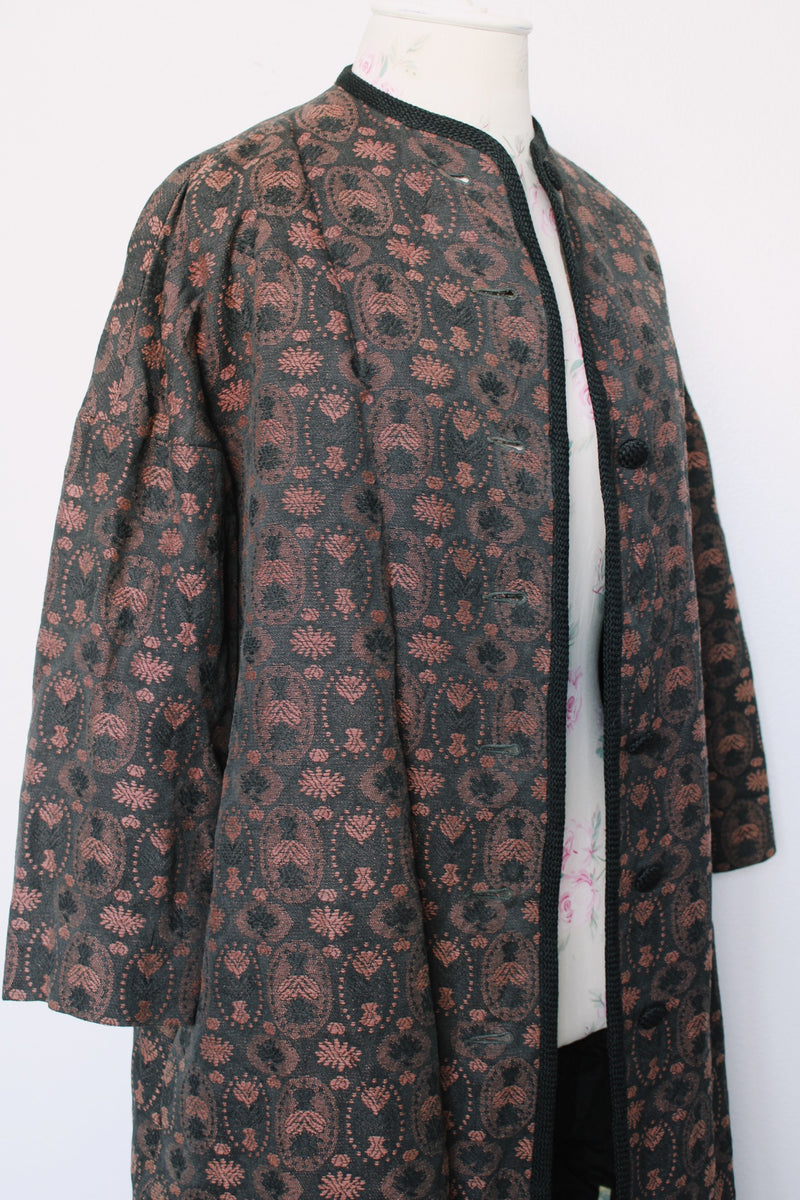 Women's vintage 1960's Helen's Fashion Shoppe, McMinnville, Oregon label long sleeve long length jacket in a black and purple tapestry print.