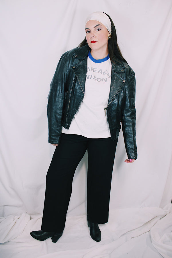 Men's or women's vintage  1970's Genuine Leather, Made in Mexico label long sleeve black leather moto leather jacket with silver hardware. 