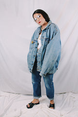Men's or women's vintage 1980's Levi's medium wash denim lightweight jacket with brass hardware. Buttons up the front and four pockets. Size XXL.