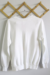 Women's or men's vintage 1980's Buffalo, Made in USA label long sleeve white crew neck pullover sweater in a polyester cotton blend material.