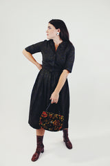 vintage 1950's paisley printed midi length dress with 3/4 arms and button up bust with small collar dark green front