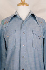 Men's vintage 1970's long sleeve chambray denim shirt with colored embroidery in the front and back. 
