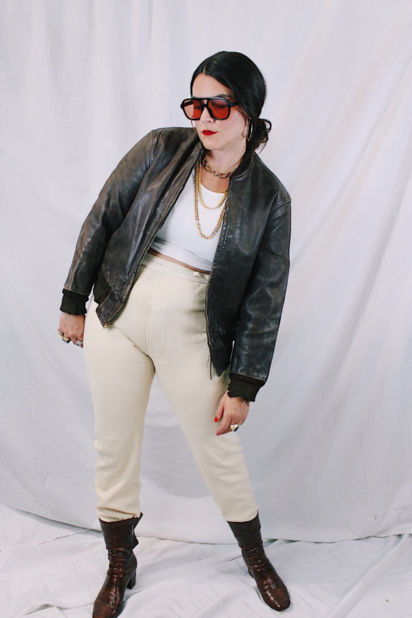 Men's or women's vintage 1950's Genuine Horsehides All Weather Garment, San Francisco, California label long sleeve brown leather bomber jacket with ribbed knit trim and quilted liner.