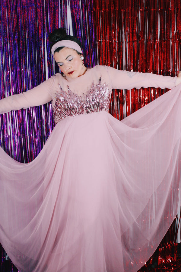 Women's vintage 1980's long sleeve long length pink maxi dress. Has sheer sleeves and sequins across the chest