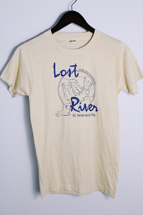 Men's or women's vintage 1980's Screen Stars, Made in USA label short sleeve light tan colored tee with blue graphic on the front in a cotton and polyester material. 
